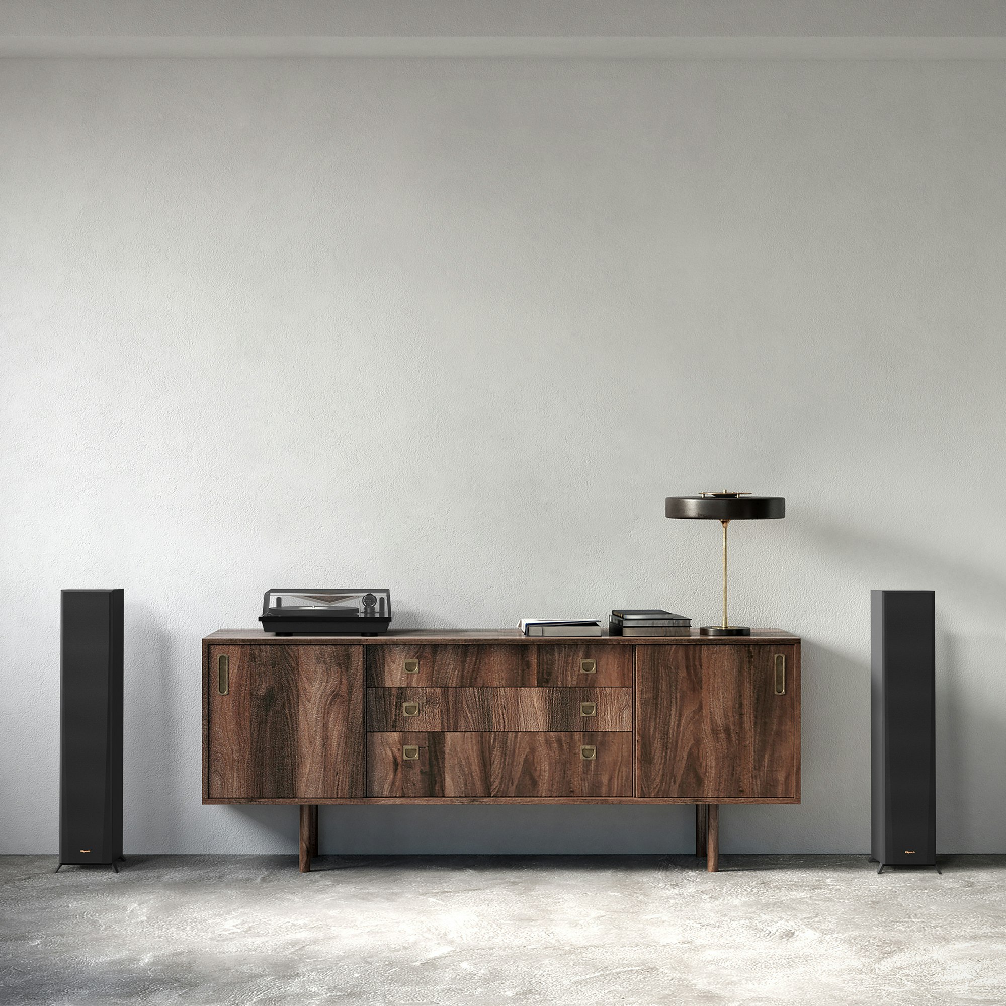 RP 5000 F speakers flanking a nice wooden credenza with a turntable lamp and books on it
